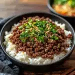 korean ground beef bowl with rice and green onions