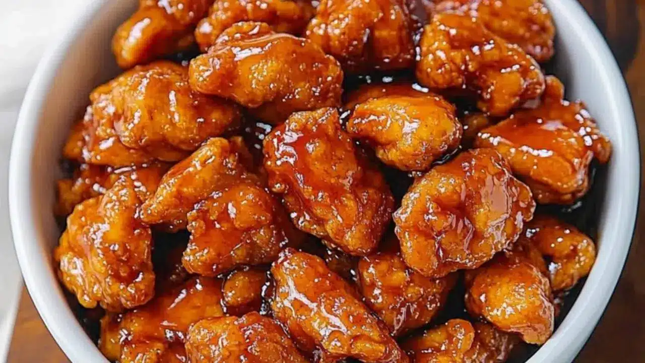 three different bowls filled with orange chicken and rice