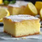 the lemon cake is cut in half and ready to be eaten