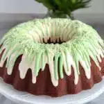a bundt cake decorated with grass and peep holes