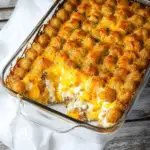 the secret spoon shepherd's pie meets tater tot casserole on a white plate