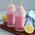 two glasses filled with whipped pink lemonade