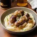 sausages and mash with guinness gravy in a skillet