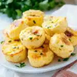 cottage cheese egg bites on a white plate with the title in the middle and an image of