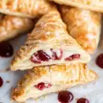 croissants filled with jelly and cream on a baking sheet, ready to be eaten