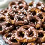 easter pretzels in the shape of cats and rabbits on a yellow plate with text overlay
