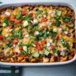 a casserole dish filled with chicken and black beans