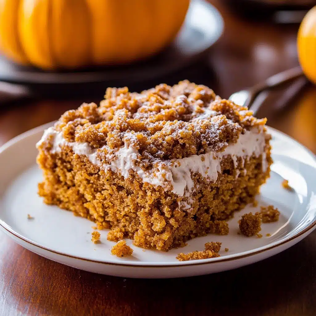 the best pumpkin crumb cake in a pan with icing drizzled on top