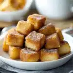 cinnamon sugar french toast muffins stacked on top of each other with text overlay