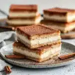 three different views of cheesecake bars stacked on top of each other with the words, churro cheesecake bars