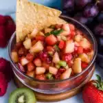 fruit salsa with cinnamon and sugar tortilla chips in glass bowls on a table