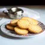 several sugary cookies stacked on top of each other with the words french butter cookies above them