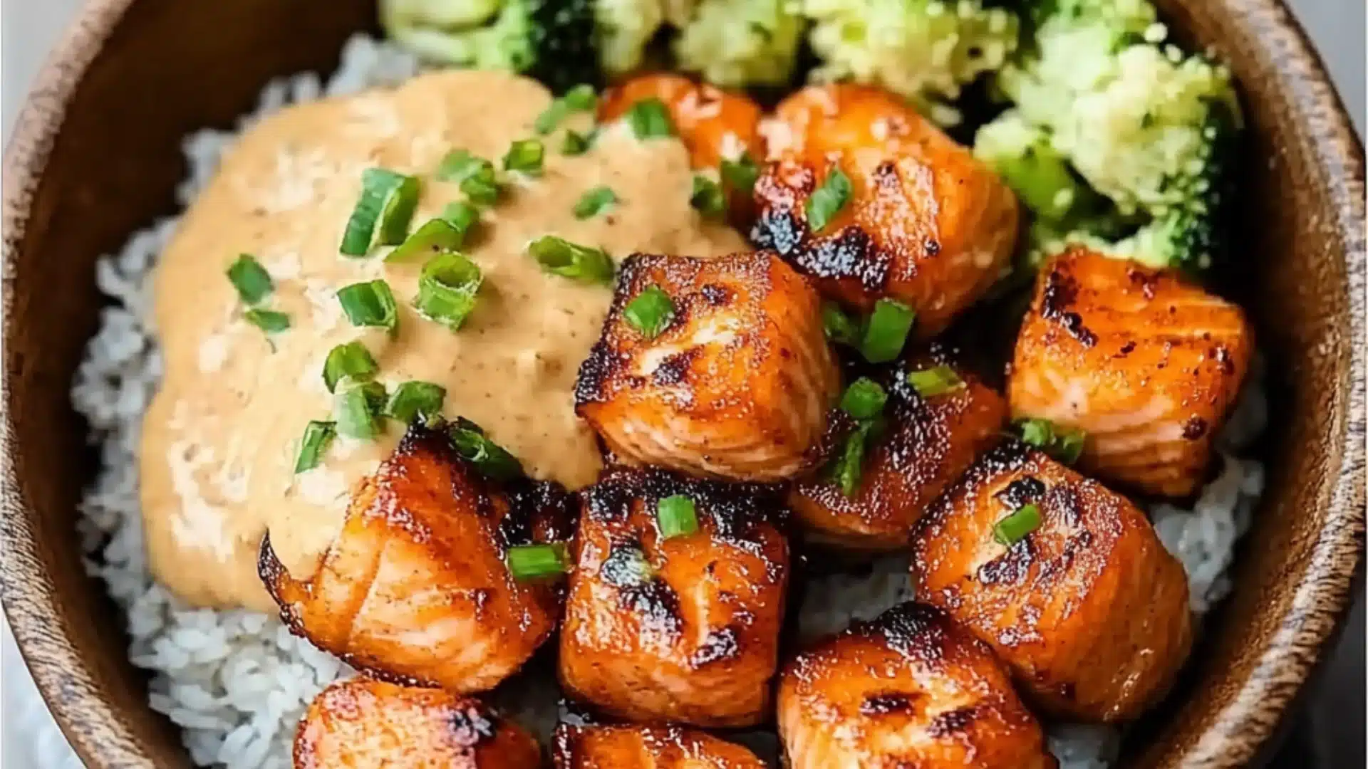 crispy bang bang salmon bites on a white plate