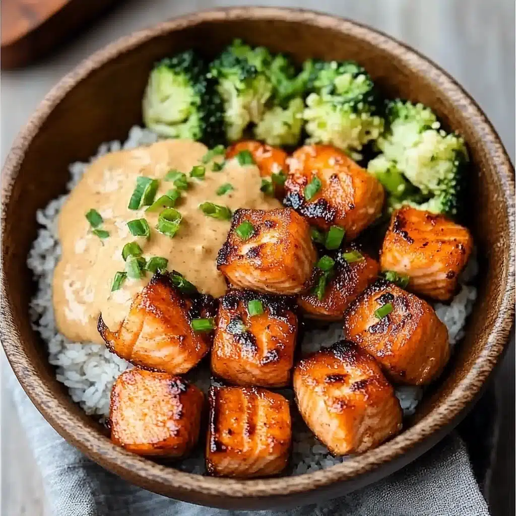 crispy bang bang salmon bites on a white plate
