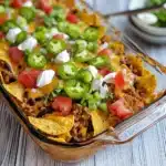 a glass casserole dish with tortilla chips and salsa