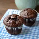 chocolate muffins stacked on top of each other with the words super moist double chocolate muffins