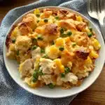 chicken cobbler casserole with cheese and crackers on the side is shown