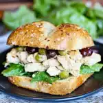 delicious chicken caesar croissant sandwich with lettuce and tomato sauce on it