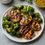 grilled chicken and broccoli bouils with creamy garlic sauce in a bowl