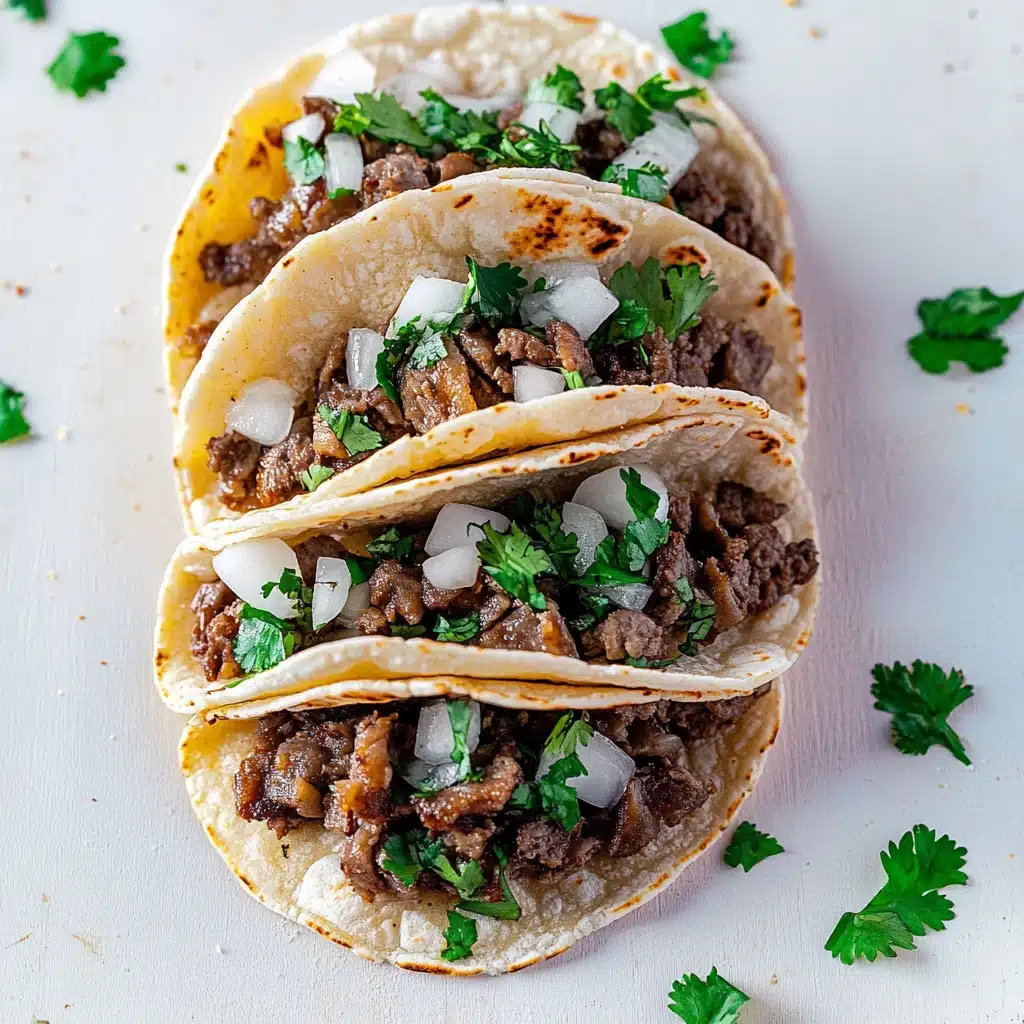 three tacos with meat, onions and cilantro