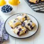 sweet blueberry biscuits on a baking sheet with text overlay that reads, sweet blueberry biscuits