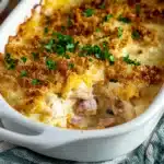 the chicken cordon bleu casserole is topped with cheese and ham