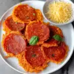 a white bowl filled with sliced up pizza chips