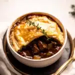 the ultimate comfort food guinness braised beef pot pie is ready to be eaten and served
