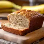 sliced banana bread on a cutting board with text overlay that reads the best banana bread