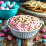 a hand dipping a cracker into an easter dip