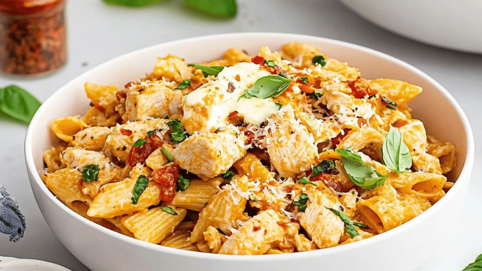 chicken mozzarella pasta in a glass casserole dish