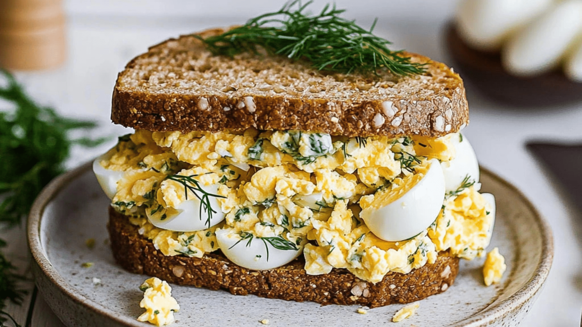 healthy high protein egg salad recipe on a plate with oranges and other food items
