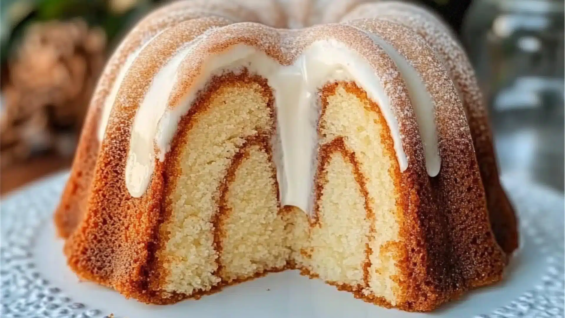 a bundt cake with white icing and cinnamon sprinkles on top