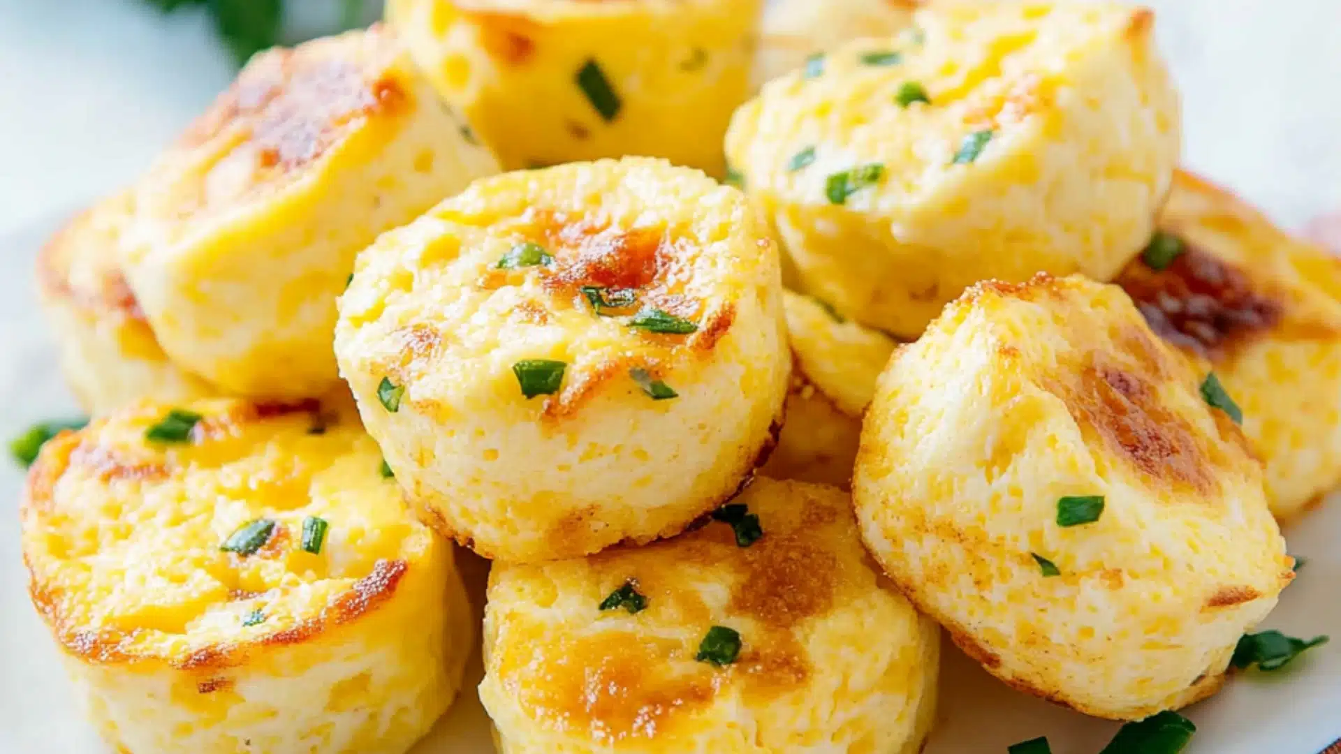 cottage cheese egg bites on a white plate with the title in the middle and an image of