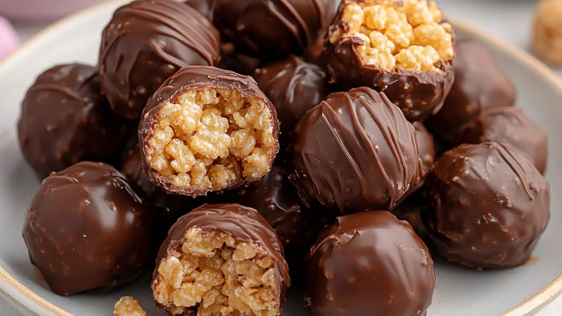 chocolate covered peanut butter balls are stacked on top of each other, with one bite taken out