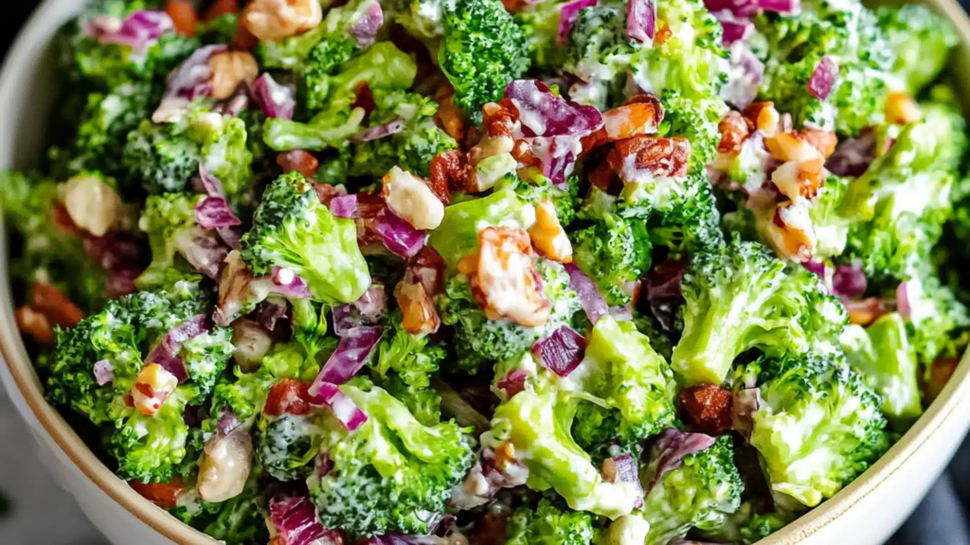 This Broccoli Salad is an Easter side dish recipe made with fresh broccoli, smoked bacon, red onion, and sliced almonds in a slightly sweet mayo base. This salad recipe is also a great addition to your Spring salad ideas!