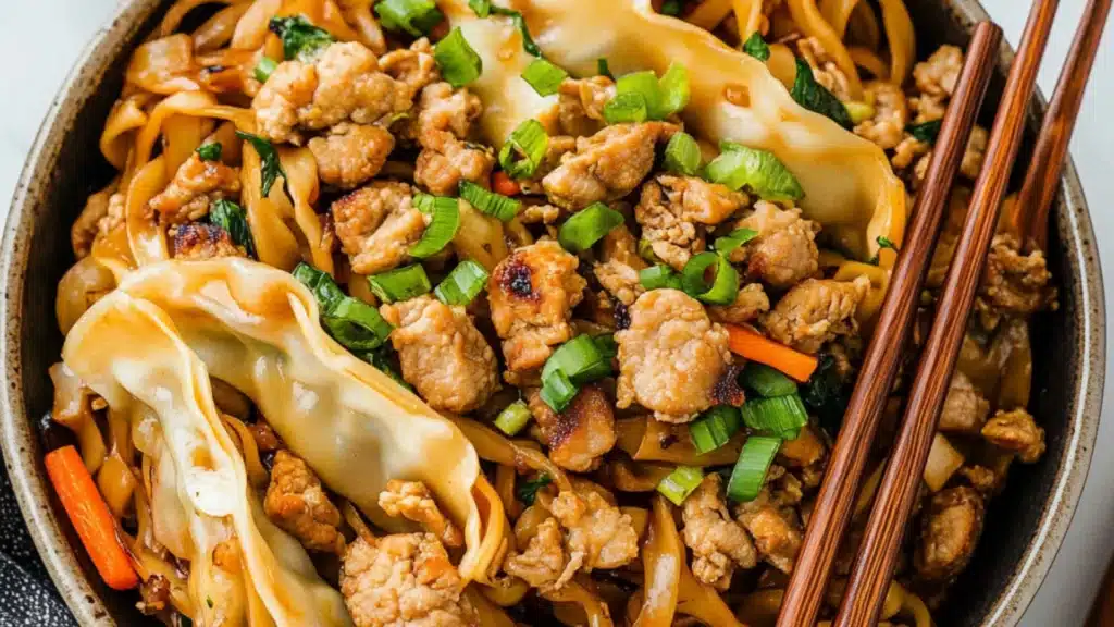 two bowls filled with noodles and topped with sauce, green onions, carrots and shredded meat