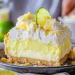 a dessert dish with cucumbers and whipped cream on top is sitting on a table