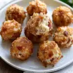 a white plate topped with mini cheese balls