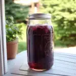 two glasses filled with blueberry soda on top of a table