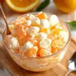 oranges and marshmallows in a bowl with text overlay that reads easy & tasty sunshine salad