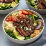 steak bowls with tomatoes, cucumbers and other vegetables