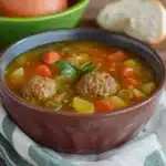 a bowl of meatball vegetable soup with the title overlay