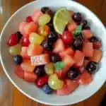 a plate topped with strawberries and mint