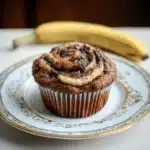 nutella banana muffins with chocolate frosting in the middle and one cut in half