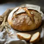 the bread has been sliced and is ready to be eaten with text overlay that reads traditional german rustic bread loaf