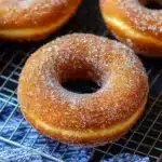 delicious homemade cinnamon sugar doughnuts with chocolate drizzle on top and bottom