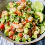 shrimp salad with avocado and tomatoes in a bowl