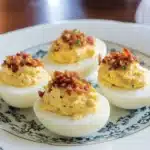 deviled eggs topped with bacon and green onions