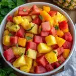 watermelon pineapple salad on a white plate